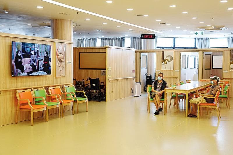 China Daily HK article: Residents watch television in the lobby at Pleasure Lodge. (EDMOND TANG / CHINA DAILY)